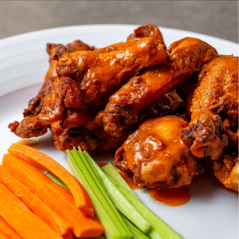 Spicy buffalo wings served with fresh carrot and celery sticks at City Cafe in Chattanooga—perfect for comfort food cravings or visitors searching for top-rated restaurants near me or brunch spots in downtown Chattanooga.